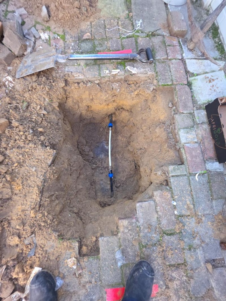 Underground pipe repair through paving