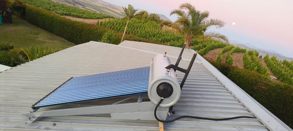 Solar geyser installed on roof at sunset