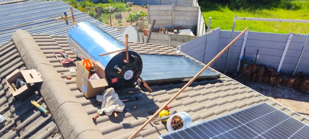 Solar geyser installation in progress on roof