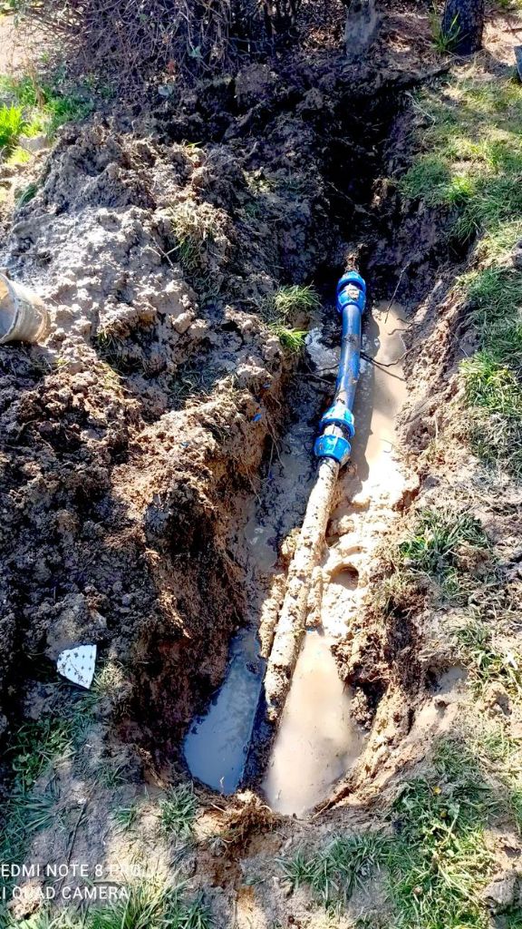 Underground water leak — muddy water filling trench