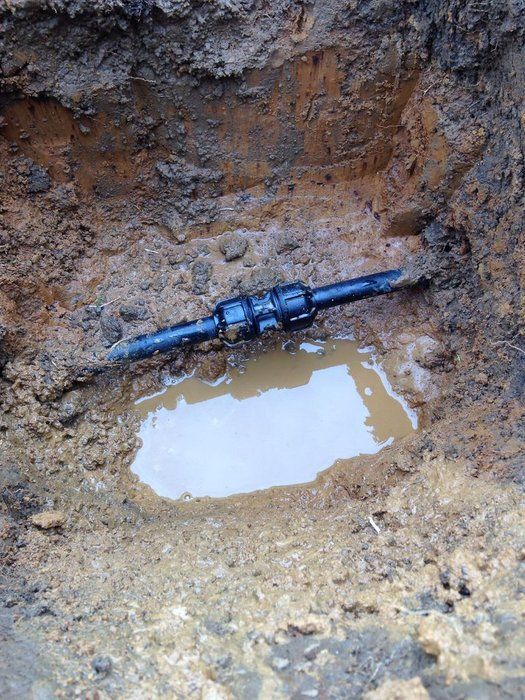 Underground pipe joint leaking — water pooling around fitting