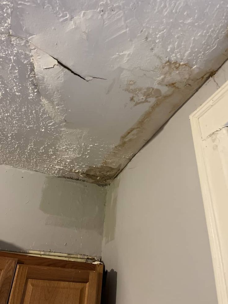 Severe ceiling water damage — paint peeling and cracking